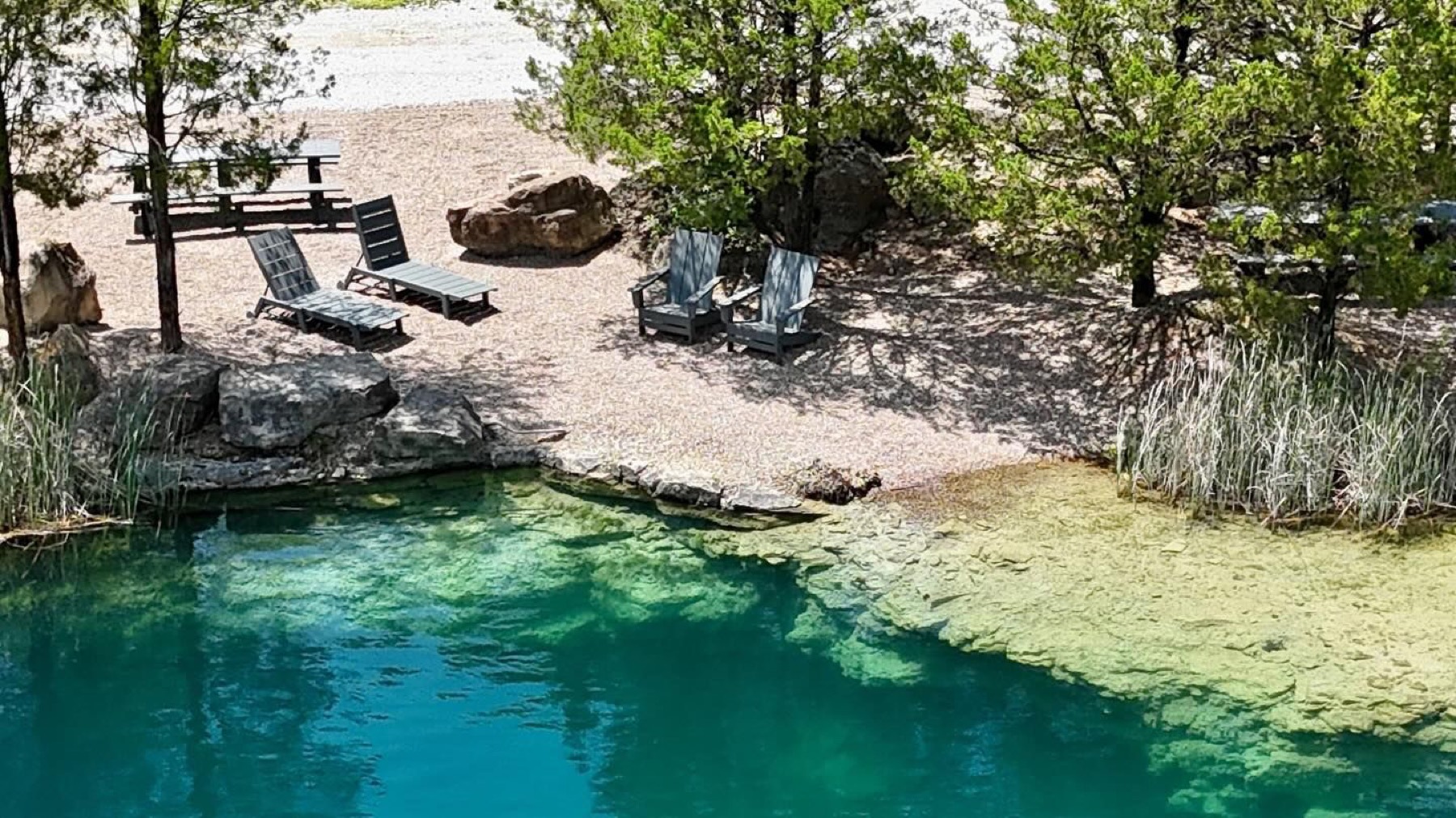 Loungers beside the emerald quarry water
