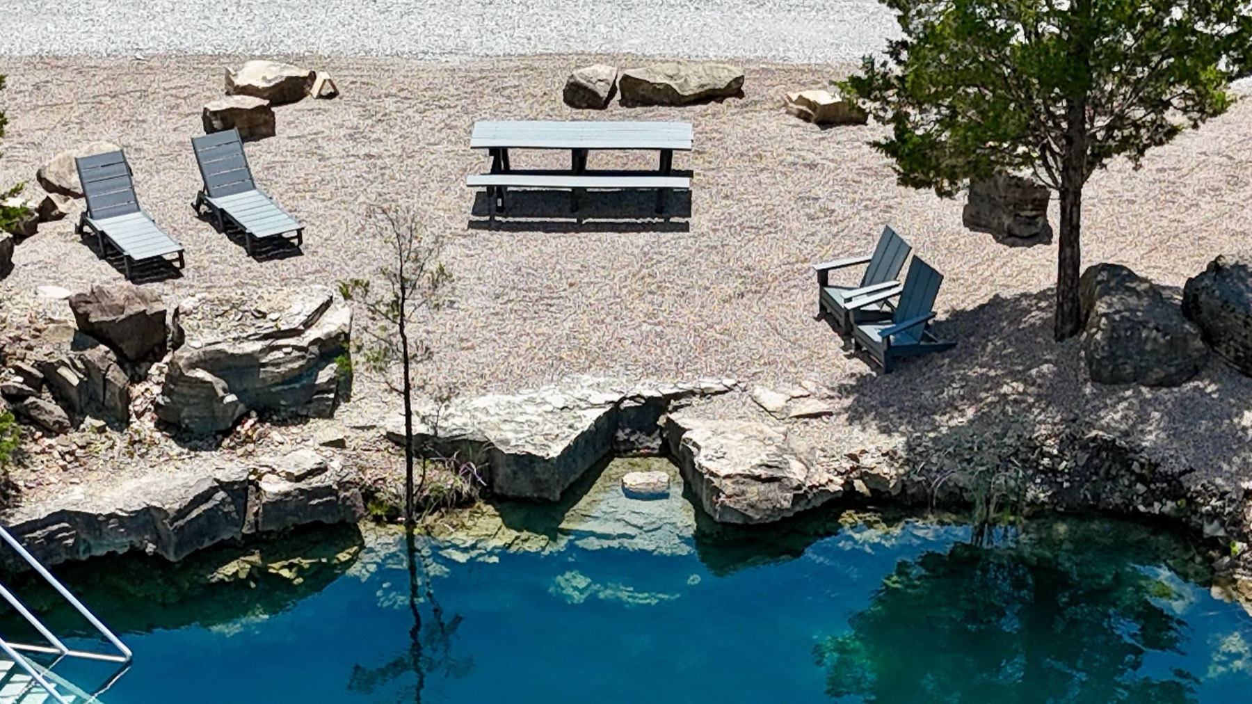 Private reserved area with loungers and picnic table at the water's edge